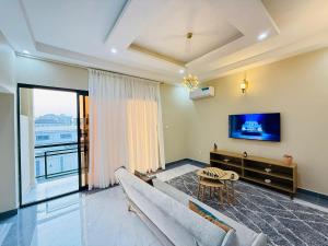 a living room with a couch and a tv at Ken-JResidence in Douala
