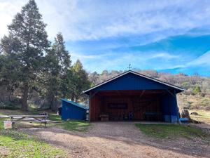 a blue barn with a cross on top of it at O'Brien's Oasis in Miramonte