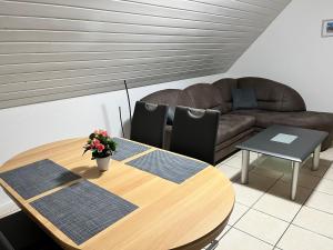 a living room with a table and a couch at Gästehaus Wettemann in Lauchheim
