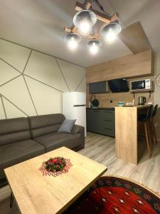una sala de estar con un sofá y una mesa en Apartment Neesi, en Pristina