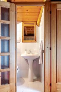 a bathroom with a sink and a mirror at Casa al Vicolo [vicino al Lago di Garda] in Cavedine