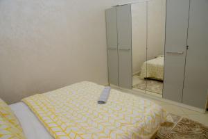 a bedroom with a bed and a mirror at Marrakech in Marrakech