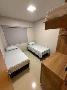a room with two beds and a window at Apartamento Amplo e Confortável em Condomínio Familiar, 3 Quartos Sendo 1 Suíte com Lazer de Clube in Belém +31 photos