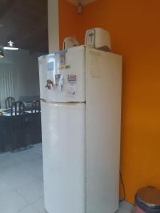 a white refrigerator sitting next to a wall at Sosiego Patagonico dpto A in Perito Moreno