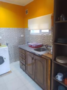 a kitchen with a sink and a counter top at Sosiego Patagonico dpto A in Perito Moreno