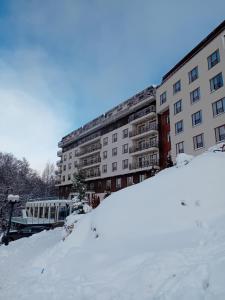 a snow covered building with a train in front of it at Milmari resort N12 in Kopaonik