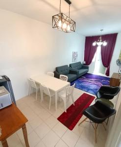 a living room with a table and a couch at Muslim Boutique Apartment with Balcony in Tanah Rata