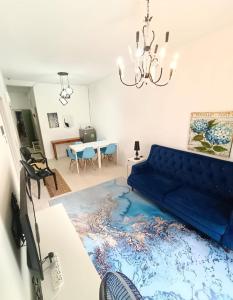 a living room with a blue couch and a table at Muslim Boutique Apartment with Balcony in Tanah Rata