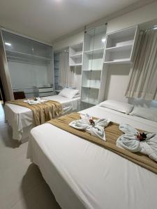 two beds in a room with towels on them at AP 103 com Piscina privativa - Flecheiras Residence Summer Plus in Trairi +25 photos