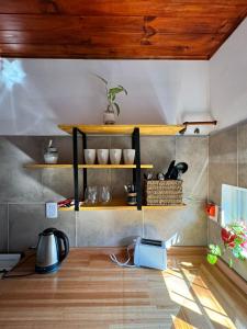 a room with shelves on the wall with a table at Casas de alquiler FIKA in Capilla del Monte