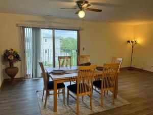 a dining room with a wooden table and chairs at 3BR-2BA Deluxe Apartment with Fireplace and Balcony in Niles