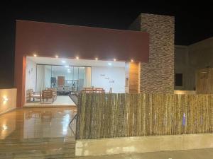 a building with a wooden fence and a patio at Lar do Patacho in Pôrto de Pedras