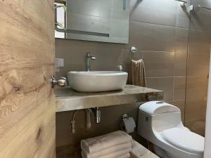 a bathroom with a sink and a toilet at SWEET BREEZE in San Andrés
