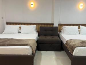 a hotel room with two beds and a couch at SWEET BREEZE in San Andrés +46 photos
