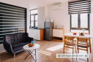 a kitchen and a living room with a couch and a table at Merci Vinhomes Imperia Hai Phong in Hai Phong