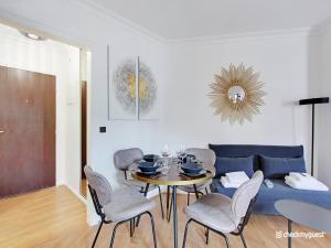 a living room with a table and chairs and a couch at Quiet and bright studio - 2P - Rueil Malmaison in Rueil-Malmaison +4 photos