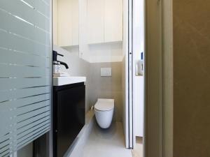 a small bathroom with a toilet and a sink at Studio COSY - 17th arrd - Mobility lease in Paris