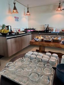 a table with glasses on it in a kitchen at Pousada Grandmar, Maragogi in Maragogi