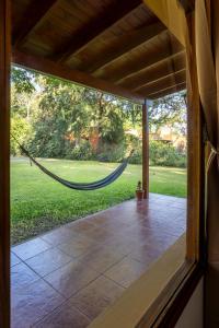 a porch with a hammock in a house at Pour Le Galerie in San Antonio de Areco