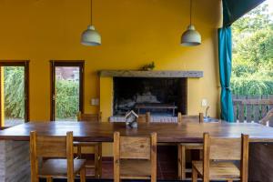a dining room with a table and chairs and a fireplace at Pour Le Galerie in San Antonio de Areco