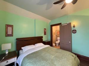 a bedroom with a large bed and a ceiling fan at THE RED STAR ROOM A in Niagara Falls