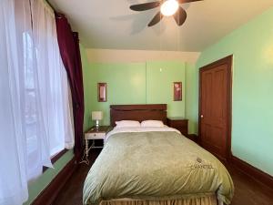 a bedroom with a bed and a ceiling fan at THE RED STAR ROOM A in Niagara Falls