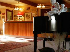 a room with a piano with a statue on top of it at Westwind Inn on the Lake in Buckhorn
