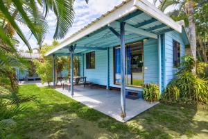 a blue house with a picnic table in front of it at Kurrimine Beach Holiday Park in Kurrimine Beach