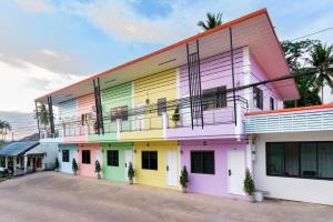 a brightly colored building with a lot of windows at Songbird Suites in Ban Khlong Haeng
