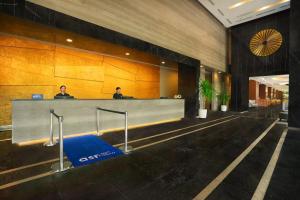two people sitting at a reception desk in a lobby at Somerset Kencana Jakarta in Jakarta +25 photos