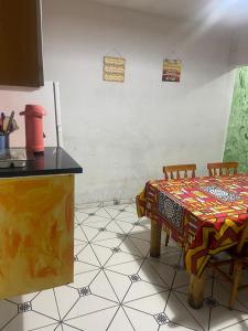 a kitchen with a table and two chairs with a table at Morada Vitória in Ubatuba