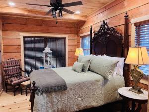 a bedroom with a bed and a ceiling fan at Turkey Creek Cabin Rentals #2 at Tims Ford lake in Tullahoma