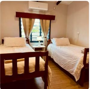 Postel nebo postele na pokoji v ubytování Tiares Homestay