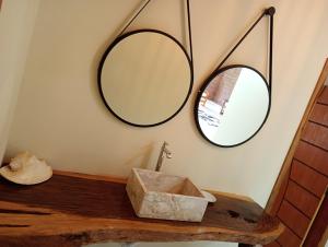 a bathroom with a sink and two mirrors on the wall at Chácara Alto Padrão em Igaratá in Igaratá +75 photos