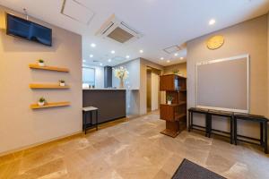 a large room with a projection screen on the wall at JA Hotel Tennoji in Osaka +5 photos