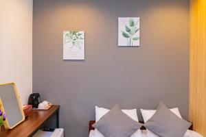 a bedroom with a bed with three pictures on the wall at JA Hotel Tennoji in Osaka