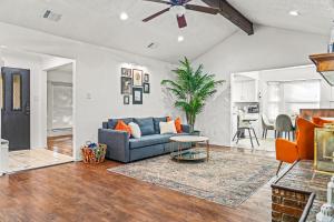 a living room with a blue couch and a table at Your Home Away from Home in Grand Prairie