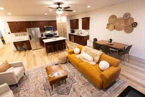 a living room with a couch and a table at Two Pines Retreat - Brand New! in Cedar City