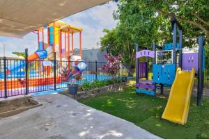 a playground with a slide in a park at Kurrimine Beach Holiday Park in Kurrimine Beach