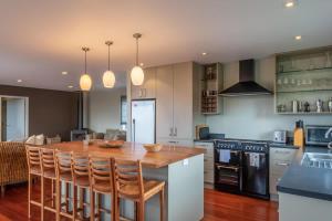 a kitchen with a wooden table and a counter top at Lake View Inn in Rotorua