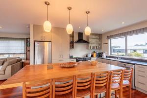 a kitchen with a large wooden table and chairs at Lake View Inn in Rotorua
