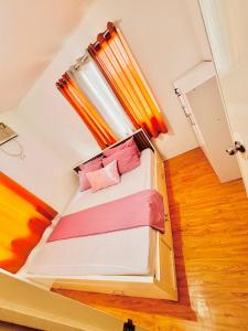 a small room with a bed with a window at House 3BR 10Pax Gran Europa, Cagayan de Oro City in Cagayan de Oro
