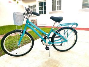 a blue bike parked in front of a house at Maddie House cerca del Río y del Mar in Tecolutla
