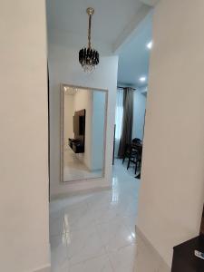 a mirror on a wall in a living room at Alyssa Homestay Arau in Kangar