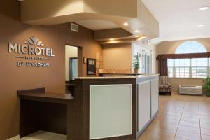 a lobby of a medical office with a counter at Microtel Inn & Suites by Wyndham in Midland