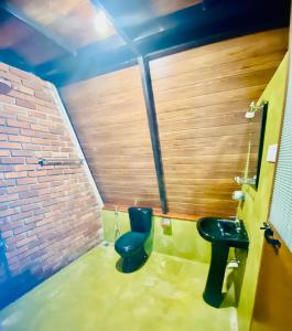 a bathroom with a blue toilet and a sink at Agora Field in Hikkaduwa