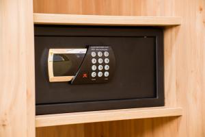 a television with a remote control in a wooden cabinet at Landhotel Zur Post in Bad König