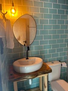 a bathroom with a sink and a mirror and a toilet at Apt Maracaipe, Porto de Galinhas in Porto De Galinhas