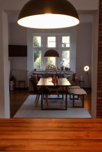 a living room with a table and a dining room at Modern Villa in Falkenberg in Falkenberg +12 photos