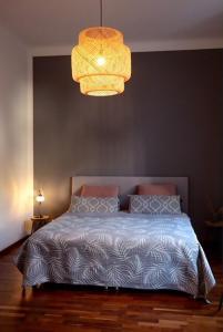 a bedroom with a bed and a chandelier at Modern Villa in Falkenberg in Falkenberg